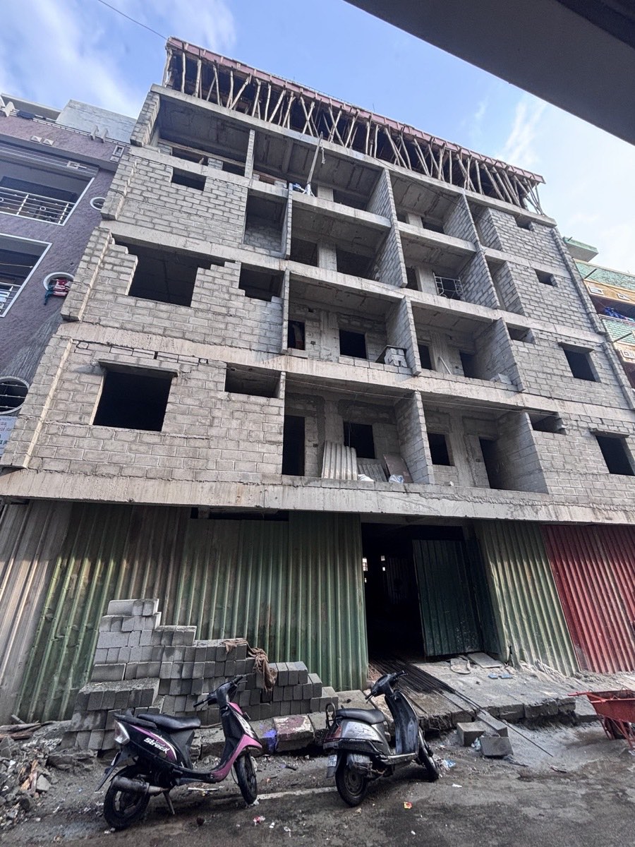 Multi-storey building under construction at masonry stage on a tight urban site in Bangalore